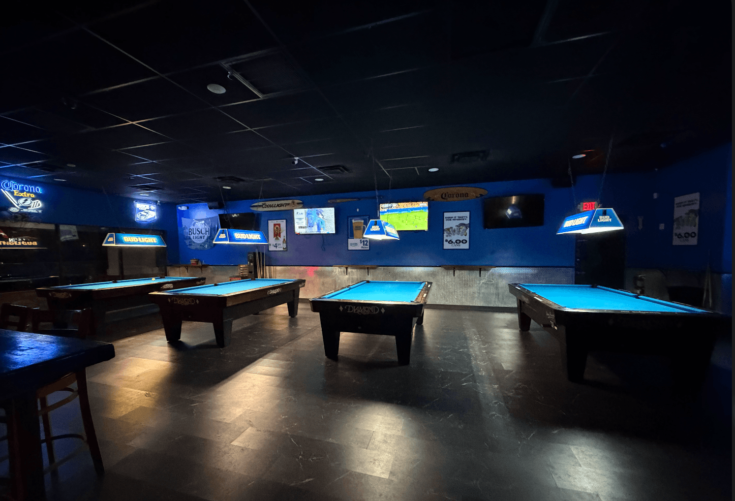 Joe Whiskey's pool room — blue felt Diamond tables under neon